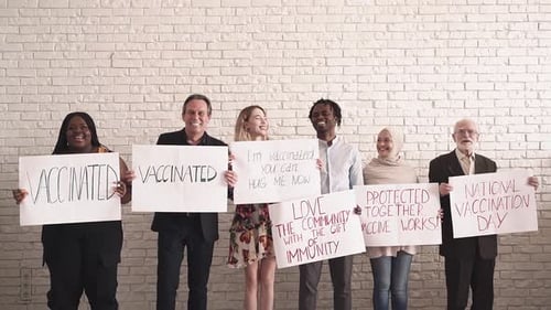 Diverse Group Holding Vaccination Signs