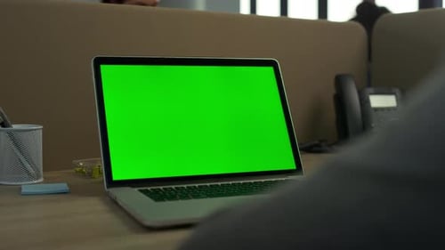 Business Man Using Green Screen Laptop Computer in Office