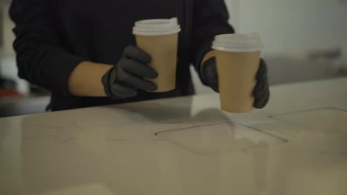 Barista Serves Coffee in Paper Cups