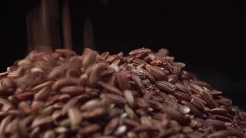 Brown Rice Spin on Table and Rice Fall Down on It. Nice Cinematic Footage.