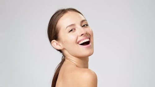 Woman Smiles and Poses in Studio, Bare Shoulders