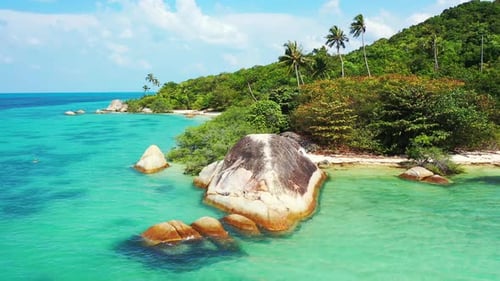 Paradise seascape with secret exotic beach hidden behind limestone cliffs on shallow turquoise lagoo