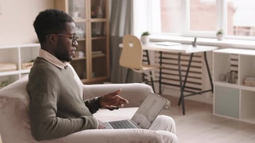 Man Communicating in a Video Call on Laptop