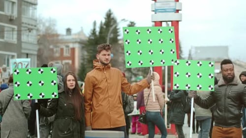 People Holding up Green Screens Protesting Outdoors