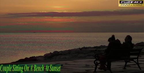Couple Sitting on Bench at Sunset Near Ocean
