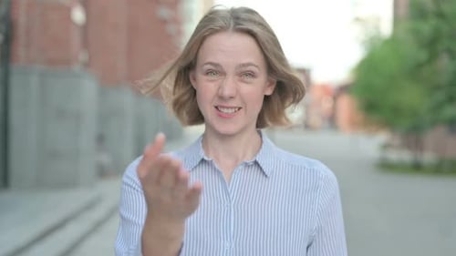 Blonde Woman Beckoning Viewer to Come Closer