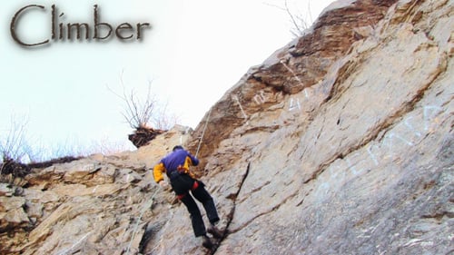 Adult Rock Climber Rappelling Down Rock Wall