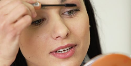 Woman Applies Mascara for Makeup Tutorial