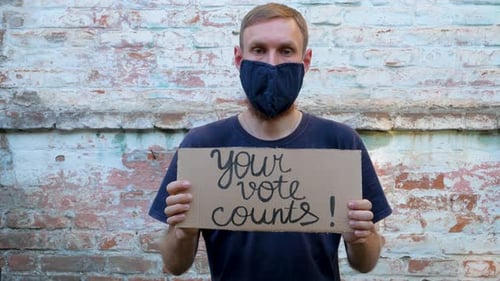 Adult Holding Your Vote Counts Sign