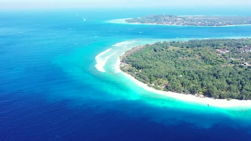 Aerial flying over landscape of exotic seashore beach holiday by blue lagoon with white sand backgro