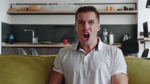 Angry Man Yelling at Camera on Couch