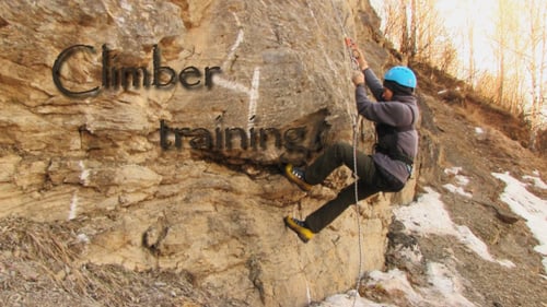 Person Rappelling Down Rocky Cliffside with Safety Gear