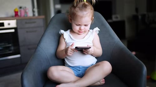 Young Child Using Smartphone in an Indoor Setting