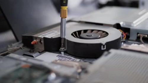 Computer Fan Being Attached with Screwdriver Close Up