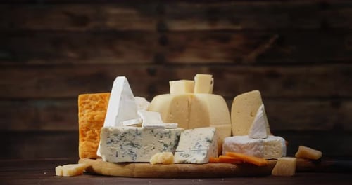 Variety of Delicious Cheeses on Wooden Cutting Board