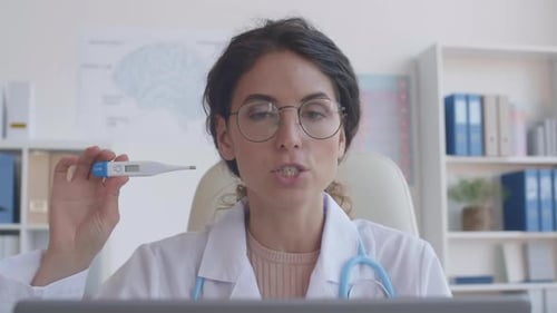 Doctor Explains Thermometer During Telemedicine Appointment