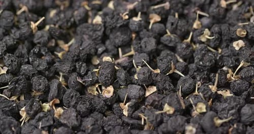 Pile of Dried Black Goji Berries Rotating