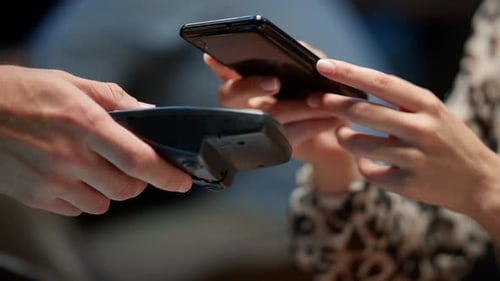 Closeup Businesswoman Hands Paying with Mobile Phone Over Pos Terminal