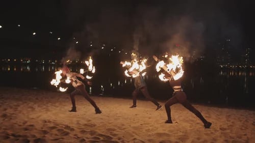 Talented Fire Dancers Performing on a Sandy Beach