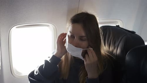 Woman Wearing Face Mask on Airplane Flight
