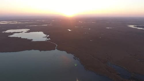 Beautiful Sunset Over Water and Marshland From Above
