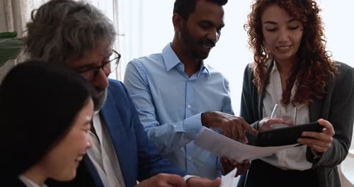 Multiracial business people working inside corporate office