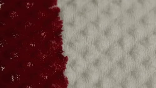 Bright Red Liquid Fills White Textured Surface