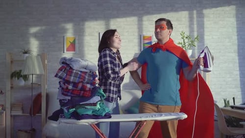 Man as Superhero Ironing Clothes for Woman