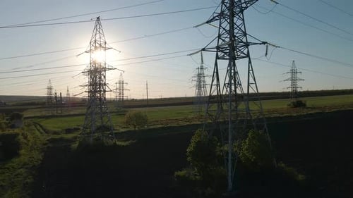 Aerial View of Electricity Pylons and High Voltage Power Line at Sunset