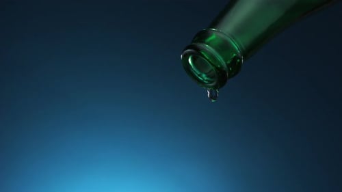 Water Dropping From Green Glass Bottle Mouth