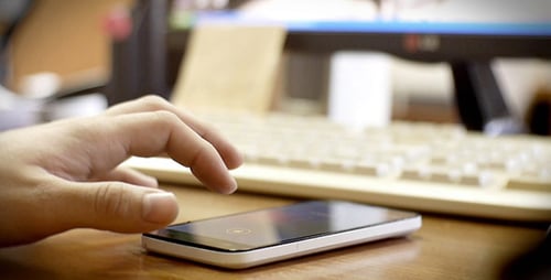 Browsing Photos On Smartphone In Office