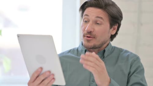 Portrait of Video Call on Tablet by Middle Aged Man