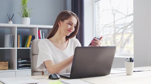 Young Woman Works at Home Office Using Computer.