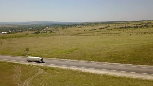Truck Driving on Highway in Rural Landscape Aerial