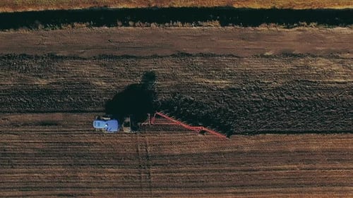 Aerial View of Tractor Plowing Field