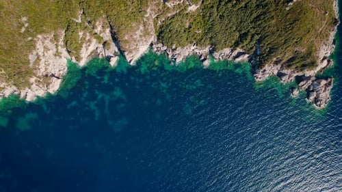 Aerial Drone View to Exotic Wild Beach with Blue Water and Cliffs