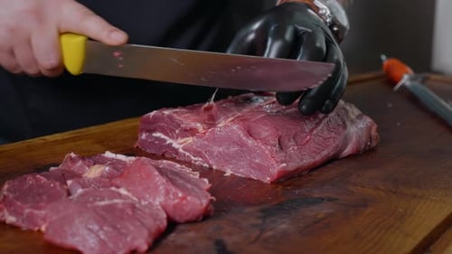 Chef Cuts Raw Beef Steak on Cutting Board