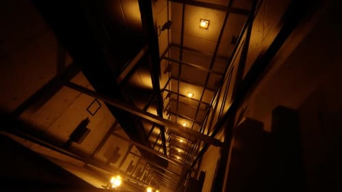 Dark Elevator Shaft Looking Up with Moving Lift Car