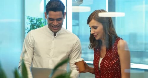 Teamwork in Modern Office with Laptop and Coffee