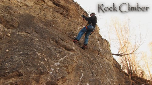 Adult Rappelling Down Rock Face on Rope
