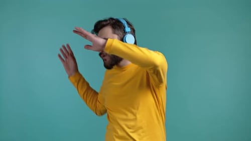 Bearded Man Dancing with Headphones, Teal Background