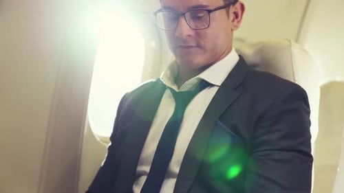 Man Sitting on Plane Working