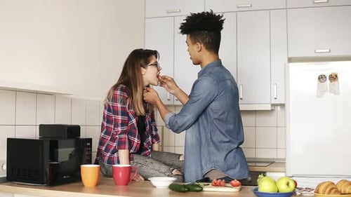 Couple Sharing Food in Bright Modern Kitchen