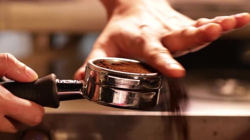 Hand Prepares Coffee in Workplace Close Up