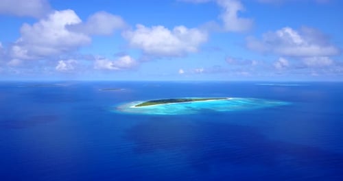 Beautiful birds eye tourism shot of a white sandy paradise beach and turquoise sea background