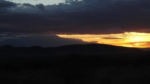 Dramatic Sunset Over Distant Mountain Landscape