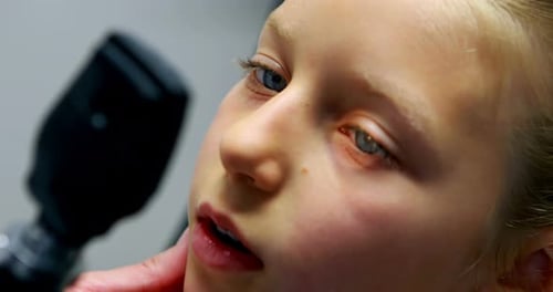 Male doctor examining patient eye