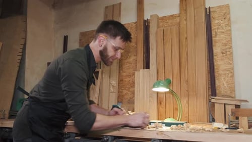 Carpenter Work With Plane On Wood Plank In Workshop