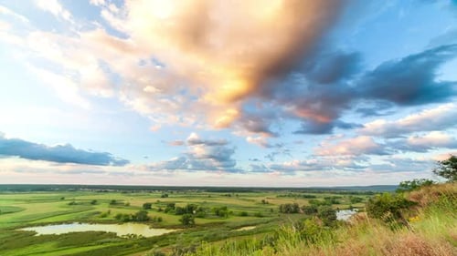 A Beautiful Valley with a River, Blue Sky with Large Clouds and Bright Sun. Aerial UHD