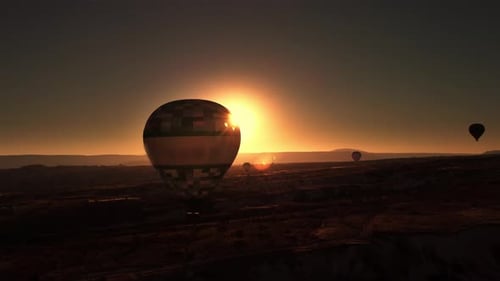 Golden Sunset and Flying Hot Air Balloons Above Valley on Mountain Ridge Background Filmed By Drone